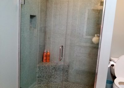 jamb mounted shower on glass tile