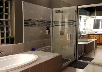 “Corner frameless shower with clear glass panels and brushed nickel hardware installed by A Cut Above Glass in Scottsdale, AZ.”