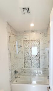 Frameless tub shower enclosure