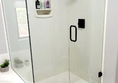 “After renovation photo showing newly installed frameless glass shower by A Cut Above Glass in Scottsdale, AZ.”